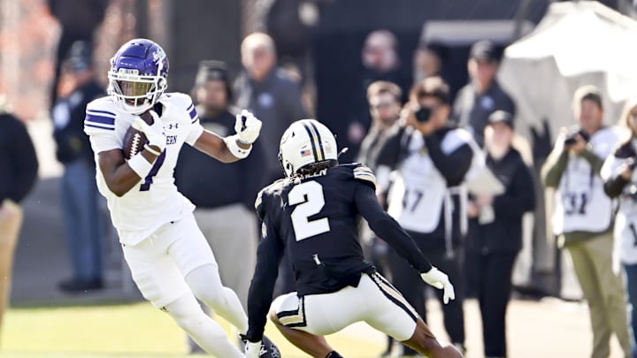 Nov 2, 2024; West Lafayette, Indiana, USA; Northwestern Wildcats wide receiver Calvin Johnson II (7) jukes to get around Purdue Boilermakers defensive back Nyland Green (2) during the first quarter at Ross-Ade Stadium. Mandatory Credit: Marc Lebryk-Imagn Images