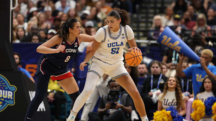 Apr 4, 2025; Tampa, FL, USA;  UCLA Bruins center Lauren Betts (51) dribbles against Connecticut Huskies center Jana El Alfy (8) during the third quarter in a semifinal of the women's 2025 NCAA tournament at Amalie Arena. Mandatory Credit: Nathan Ray Seebeck-Imagn Images