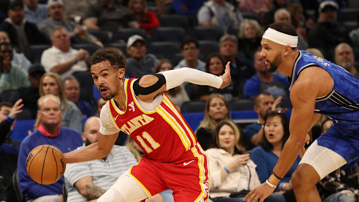 Jan 7, 2024; Orlando, Florida, USA; Atlanta Hawks guard Trae Young (11) drives to the basket as  Orlando Magic guard Jalen Suggs (4) defends during the first quarter at Kia Center. Mandatory Credit: Kim Klement Neitzel-USA TODAY Sports