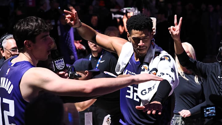 Dec 27, 2025; Sacramento, California, USA; Sacramento Kings center Maxime Raynaud (42) and center Dylan Cardwell (32) light the beam after the game against the Dallas Mavericks at Golden 1 Center. Mandatory Credit: Kelley L Cox-Imagn Images