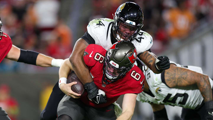Dec 24, 2023; Tampa, Florida, USA;  Tampa Bay Buccaneers quarterback Baker Mayfield (6) is sacked by Jacksonville Jaguars linebacker Travon Walker (44) in the fourth quarter at Raymond James Stadium. Mandatory Credit: Nathan Ray Seebeck-Imagn Images