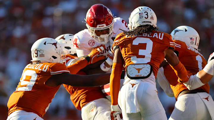 Texas Longhorns linebacker Colin Simmons (1) and Zina Umeozulu (19) tackle Oklahoma Sooners running back Xavier Robinson (24) during the second half, Oct. 11, 2025 at the Cotton Bowl in Dallas, Texas. Texas Longhorns linebacker Colin Simmons (1) and Zina Umeozulu (19) tackle Oklahoma Sooners running back Xavier Robinson (24) during the second half, Oct. 11, 2025 at the Cotton Bowl in Dallas, Texas.