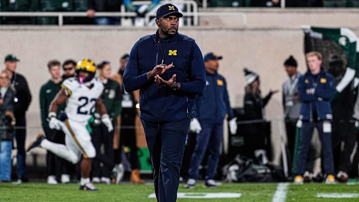 Michigan head coach Sherrone Moore watches warm up at Spartan Stadium in East Lansing on Saturday, October 25, 2025. Michigan head coach Sherrone Moore watches warm up at Spartan Stadium in East Lansing on Saturday, October 25, 2025.