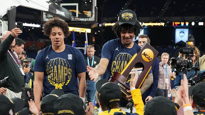 Apr 6, 2026; Indianapolis, IN, USA; Michigan Wolverines guard Howard Eisley Jr. (7) and guard Elliot Cadeau (3) with fans after the National Championship of the Final Four of the men's 2026 NCAA Tournament at Lucas Oil Stadium. Mandatory Credit: Bob Donnan-Imagn Images