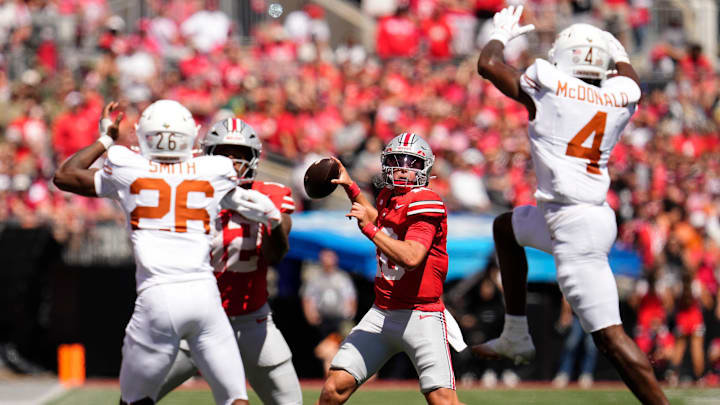 Aug 30, 2025; Columbus, Ohio, USA; Ohio State Buckeyes quarterback Julian Sayin (10) throws past Texas Longhorns defensive back Jelani McDonald (4) during the first half at Ohio Stadium. Mandatory Credit: Adam Cairns - Imagn Images