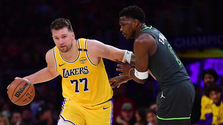 Apr 30, 2025; Los Angeles, California, USA; Los Angeles Lakers guard Luka Doncic (77) controls the ball against Minnesota Timberwolves guard Anthony Edwards (5) during the first half in game five of first round for the 2025 NBA Playoffs at Crypto.com Arena. Mandatory Credit: Gary A. Vasquez-Imagn Images