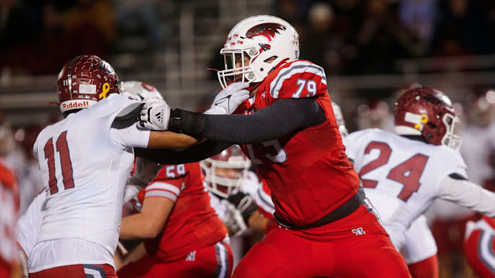 Nixa Eagles Jackson Cantwell holds back a Joplin defender during the championship game of Class 6 District 5 football at Nixa on Friday, Nov. 11, 2023.