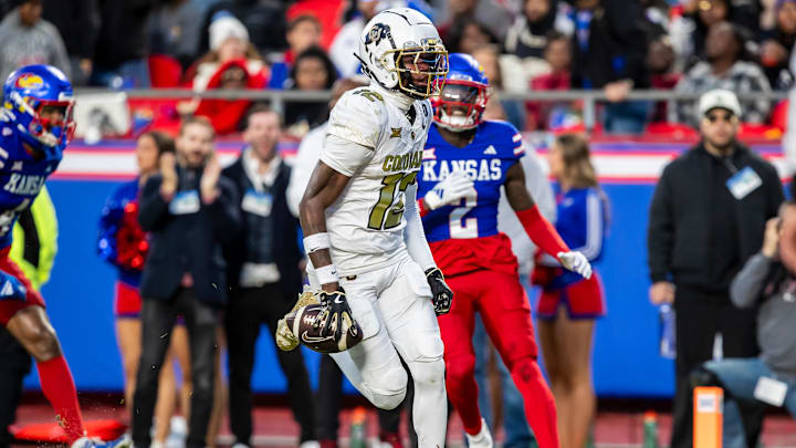 Nov 23, 2024; Kansas City, Missouri, USA;  Colorado wide receiver Travis Hunter (12) catches the ball for a touchdown  during the 3rd quarter between the Kansas Jayhawks and the Colorado Buffaloes at GEHA Field at Arrowhead Stadium. Mandatory Credit: Nick Tre. Smith-Imagn Images