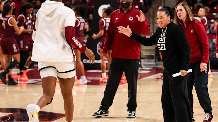 Dec 7, 2025; Columbia, South Carolina, USA; South Carolina Gamecocks head coach Dawn Staley high fives her players before the game against the North Carolina Central Eagles in the first half at Colonial Life Arena. Mandatory Credit: Jeff Blake-Imagn Images