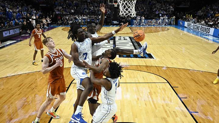 Mar 19, 2026; Portland, OR, USA; BYU Cougars center Keba Keita (13) and forward Khadim Mboup (7) defend Texas Longhorns guard Tramon Mark (12) in the second half during a first round game of the men's 2026 NCAA Tournament at Moda Center. Mandatory Credit: Troy Wayrynen-Imagn Images