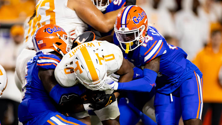 Sep 16, 2023; Gainesville, Florida, USA; Florida Gators linebacker Shemar James (6) and Florida Gators safety Jordan Castell (14) tackle Tennessee Volunteers running back Jaylen Wright (0) during the second half at Ben Hill Griffin Stadium. Mandatory Credit: Matt Pendleton-Imagn Images