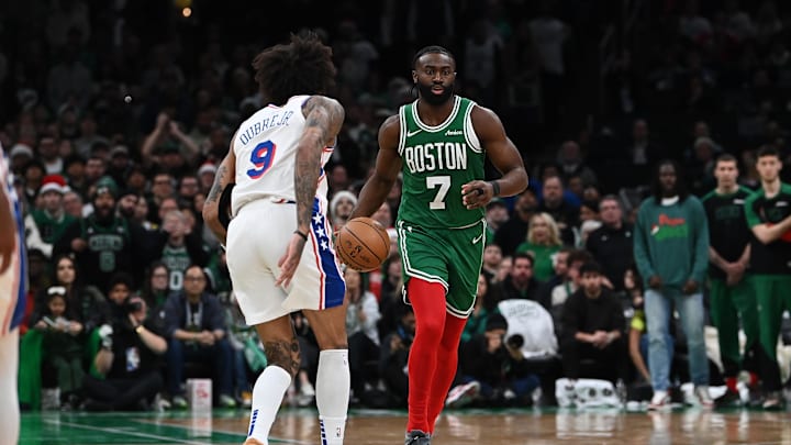 Dec 25, 2024; Boston, Massachusetts, USA; Boston Celtics guard Jaylen Brown (7) dribbles against Philadelphia 76ers guard Kelly Oubre Jr. (9) during the second half at TD Garden. Mandatory Credit: Eric Canha-Imagn Images