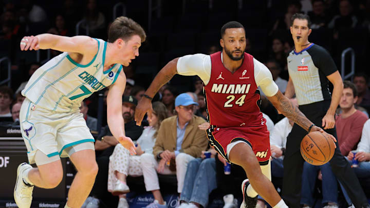 Nov 7, 2025; Miami, Florida, USA; Miami Heat guard Norman Powell (24) drives to the basket against Charlotte Hornets guard Kon Knueppel (7) during the third quarter of an NBA Cup game at Kaseya Center. Mandatory Credit: Sam Navarro-Imagn Images