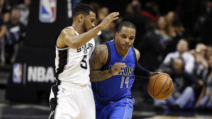 Jameer Nelson drives on the Spurs' Cory Joseph in 2014.
