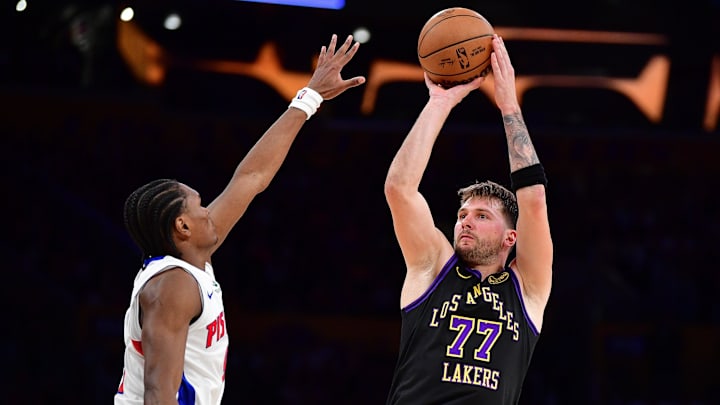 Dec 30, 2025; Los Angeles, California, USA; Los Angeles Lakers guard Luka Doncic (77) shoots against Detroit Pistons guard Ausar Thompson (9) during the second half at Crypto.com Arena. Mandatory Credit: Gary A. Vasquez-Imagn Images