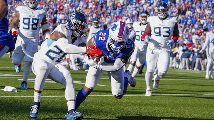 Oct 20, 2024; Orchard Park, New York, USA; Buffalo Bills running back Ray Davis (22) runs with the ball for a touchdown against Tennessee Titans safety Quandre Diggs (28) during the second half at Highmark Stadium. Mandatory Credit: Gregory Fisher-Imagn Images