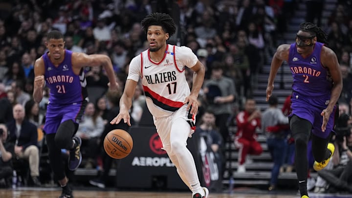 Apr 3, 2025; Toronto, Ontario, CAN; Portland Trail Blazers guard Shaedon Sharpe (17) dribles past Toronto Raptors center Orlando Robinson (21) and forward Jonathan Mogbo (2) during the second half at Scotiabank Arena. Mandatory Credit: John E. Sokolowski-Imagn Images