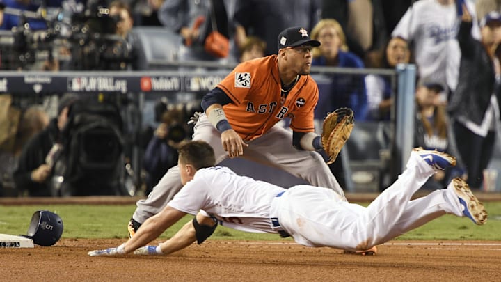 Nov 1, 2017; Los Angeles, CA, USA; Los Angeles Dodgers first baseman Cody Bellinger (35) dives back to first against Houston Astros first baseman Yuli Gurriel (10) in the third inning in game seven of the 2017 World Series at Dodger Stadium. 