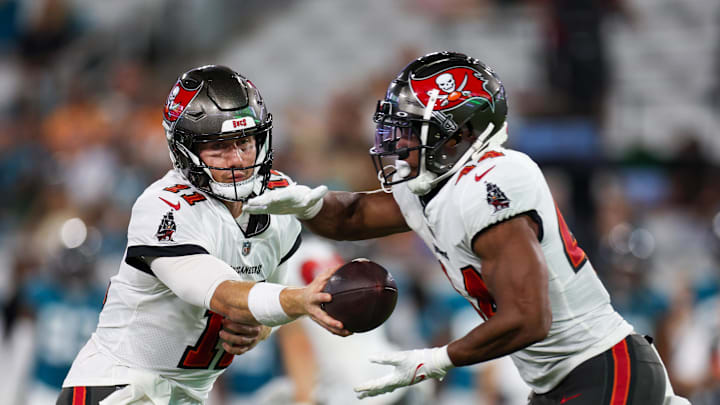 Aug 17, 2024; Jacksonville, Florida, USA; Tampa Bay Buccaneers quarterback John Wolford (11) hands off to running back Sean Tucker (44) against the Jacksonville Jaguars in the third quarter during a preseason game at EverBank Stadium. Mandatory Credit: Nathan Ray Seebeck-Imagn Images