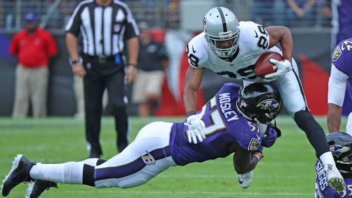 Baltimore Ravens linebacker CJ Mosley dives to tackle Oakland Raiders wide receiver Amari Cooper. Mandatory Credit: Mitch Stringer-Imagn Images