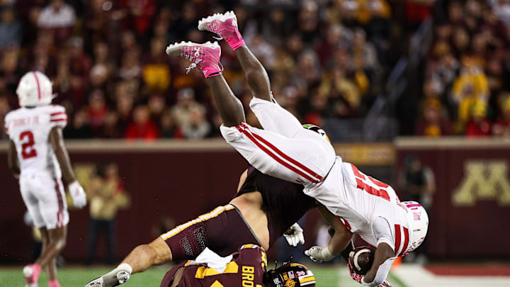 Minnesota Golden Gophers defensive back Kerry Brown tackles Nebraska Cornhuskers running back Emmett Johnson