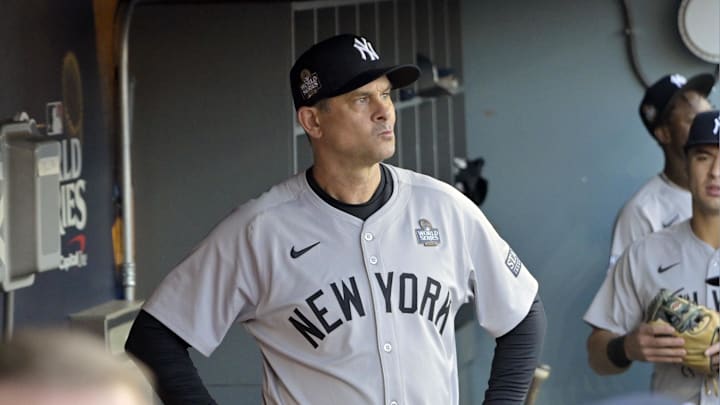 Oct 25, 2024; Los Angeles, California, USA; New York Yankees manager Aaron Boone (17) looks on from the dugout before Game 1 against the Los Angeles Dodgers in the 2024 MLB World Series at Dodger Stadium. Mandatory Credit: Jayne Kamin-Oncea-Imagn Images