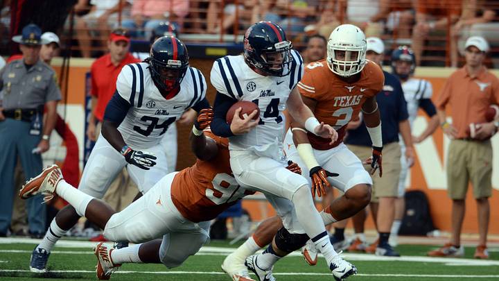 Ole Miss Rebels quarterback Bo Wallace carries the ball against the Texas Longhorns during the first half at Darrell K Royal-Texas Memorial Stadium. 