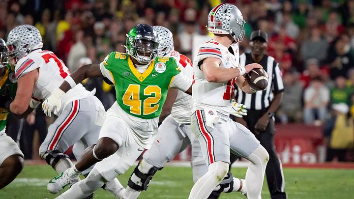 Oregon defensive lineman Aydin Breland, left, pressures Ohio State quarterback Will Howard as the Oregon Ducks face the Ohio State Buckeyes Wednesday, Jan. 1, 2025, in the quarterfinal of the College Football Playoff at the Rose Bowl in Pasadena, Calif.
