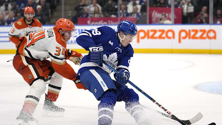 Dec 12, 2024; Toronto, Ontario, CAN; Toronto Maple Leafs forward Pontus Holmberg (29) skates with the puck as Anaheim Ducks defenseman Pavel Mintyukov (34) defends during the third period at Scotiabank Arena. Mandatory Credit: John E. Sokolowski-Imagn Images