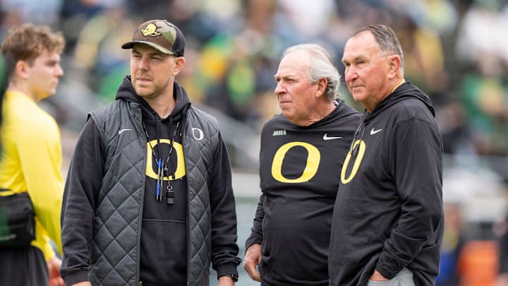 Oregon offensive coordinator Will Stein, left, former Oregon defensive coordinator Nick Aliotti and former Oregon coach Rich Brooks talk before the game as the Fighting Ducks face off against Mighty Oregon in the Oregon Ducks spring game on April 26, 2025, at Autzen Stadium in Eugene.