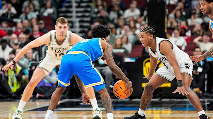 Michigan State center Carson Cooper (15) and guard Jeremy Fears Jr. (1) defend UCLA guard Donovan Dent (2) during the second half of Big Ten tournament quarterfinal at United Center in Chicago on Friday, March 13, 2026.