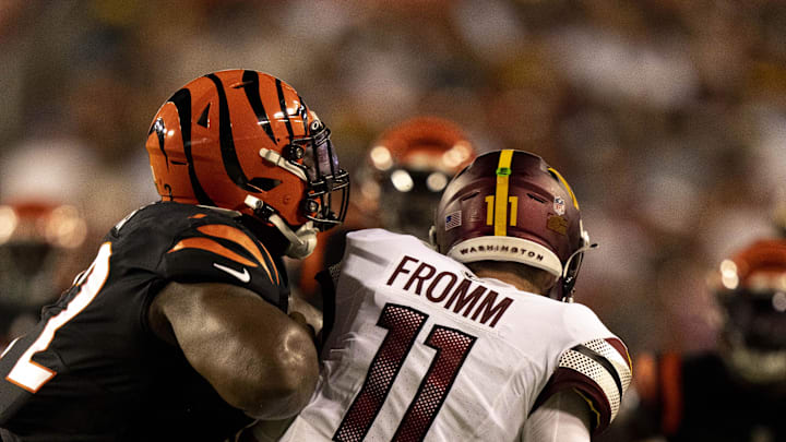 Aug 26, 2023; Landover, Maryland, USA;  Cincinnati Bengals defensive tackle Domenique Davis (72) hits Washington Commanders quarterback Jake Fromm (11) in the fourth quarter of the NFL preseason week 3 game between the Cincinnati Bengals and the Washington Commanders at FedEx Field. Mandatory Credit: Albert Cesare-Imagn Images