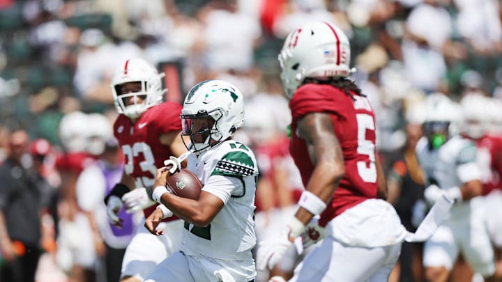 Aug 23, 2025; Honolulu, Hawaii, USA; Hawaii Rainbow Warriors quarterback Micah Alejado (12) runs through the Stanford Cardinal defense during the first half of an NCAA college football game at Clarence T.C. Ching Athletics Complex. Mandatory Credit: Marco Garcia-Imagn Images