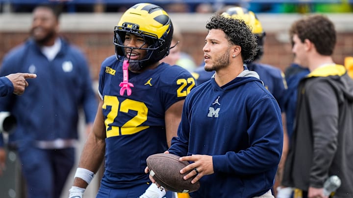 Former Michigan running back Blake Corum talks to running back Justice Haynes (22) at warm up before the spring game at Michigan Stadium in Ann Arbor on Saturday, April 19, 2025.