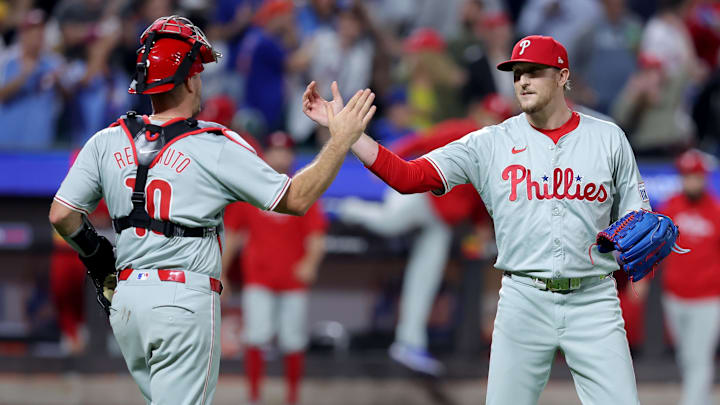 Sep 20, 2024; New York City, New York, USA; Philadelphia Phillies relief pitcher Jeff Hoffman (23) and catcher J.T. Realmuto (10) celebrate after defeating the New York Mets at Citi Field. Mandatory Credit: Brad Penner-Imagn Images