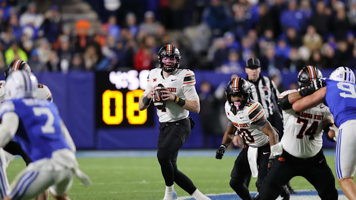 Oct 18, 2024; Provo, Utah, USA; Oklahoma State Cowboys quarterback Alan Bowman (7) drops back to pass against the Brigham Young Cougars during the fourth quarter at LaVell Edwards Stadium. Mandatory Credit: Rob Gray-Imagn Images Oct 18, 2024; Provo, Utah, USA; Oklahoma State Cowboys quarterback Alan Bowman (7) drops back to pass against the Brigham Young Cougars during the fourth quarter at LaVell Edwards Stadium. Mandatory Credit: Rob Gray-Imagn Images