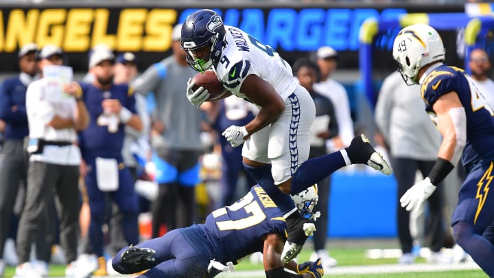 Oct 23, 2022; Inglewood, California, USA; Seattle Seahawks running back Kenneth Walker III (9) moves the ball against Los Angeles Chargers cornerback J.C. Jackson (27) during the first half at SoFi Stadium. Oct 23, 2022; Inglewood, California, USA; Seattle Seahawks running back Kenneth Walker III (9) moves the ball against Los Angeles Chargers cornerback J.C. Jackson (27) during the first half at SoFi Stadium.