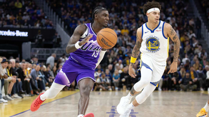 Apr 14, 2024; San Francisco, California, USA; Utah Jazz guard Kira Lewis Jr. (13) drives around Golden State Warriors guard Lester Quinones (25) during the third quarter at Chase Center. Mandatory Credit: D. Ross Cameron-USA TODAY Sports
