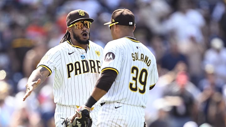 Jun 26, 2024; San Diego, California, USA; San Diego Padres third baseman Eguy Rosario (left) and first baseman Donovan Solano (39) celebrate on the field after defeating the Washington Nationals at Petco Park. Mandatory Credit: Orlando Ramirez-Imagn Images
