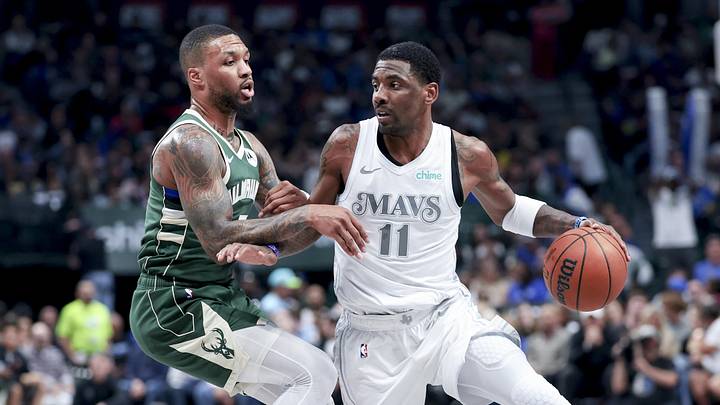 Mar 1, 2025; Dallas, Texas, USA;  Dallas Mavericks guard Kyrie Irving (11) controls the ball as Milwaukee Bucks guard Damian Lillard (0) defends during the first half at American Airlines Center. Mandatory Credit: Kevin Jairaj-Imagn Images