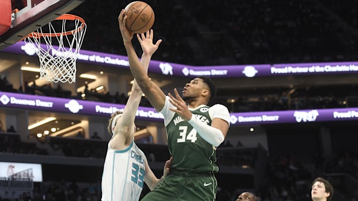Dec 29, 2025; Charlotte, North Carolina, USA;  Milwaukee Bucks forward Giannis Antetokounmpo (34) drives in past Charlotte Hornets forward Liam McNeeley (33) during the first half at the Spectrum Center. Mandatory Credit: Sam Sharpe-Imagn Images
