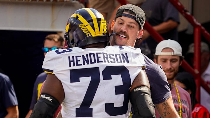 Sep 30, 2023; Lincoln, Nebraska, USA; Taylor Lewan greets Michigan Wolverines offensive lineman LaDarius Henderson (73) before the game against the Nebraska Cornhuskers at Memorial Stadium. Mandatory Credit: Dylan Widger-Imagn Images Sep 30, 2023; Lincoln, Nebraska, USA; Taylor Lewan greets Michigan Wolverines offensive lineman LaDarius Henderson (73) before the game against the Nebraska Cornhuskers at Memorial Stadium. Mandatory Credit: Dylan Widger-Imagn Images