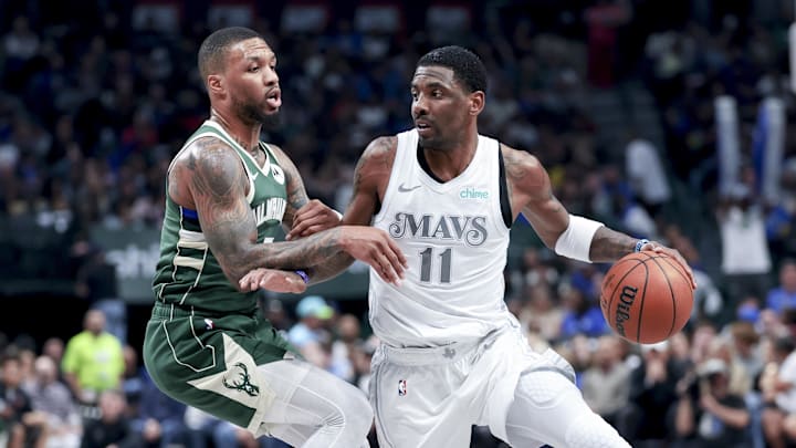 Dallas Mavericks guard Kyrie Irving controls the ball as Milwaukee Bucks guard Damian Lillard defends. Dallas Mavericks guard Kyrie Irving controls the ball as Milwaukee Bucks guard Damian Lillard defends.