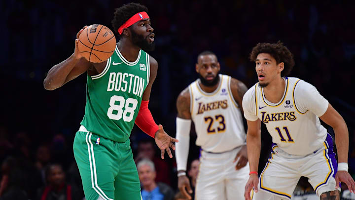 Dec 25, 2023; Los Angeles, California, USA; dBoston Celtics center Neemias Queta (88) moves the ball against Los Angeles Lakers center Jaxson Hayes (11) during the first half at Crypto.com Arena. Mandatory Credit: Gary A. Vasquez-Imagn Images