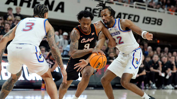 Oklahoma State Cowboys guard Anthony Roy (9) dribbles beside Kansas Jayhawks guard Darryn Peterson (22) during a men's college basketball game between the Oklahoma State Cowboys and the Kansas Jayhawks at Gallagher-Iba Arena in Stillwater, Okla., Wednesday, Feb. 18, 2026. Oklahoma State Cowboys guard Anthony Roy (9) dribbles beside Kansas Jayhawks guard Darryn Peterson (22) during a men's college basketball game between the Oklahoma State Cowboys and the Kansas Jayhawks at Gallagher-Iba Arena in Stillwater, Okla., Wednesday, Feb. 18, 2026.