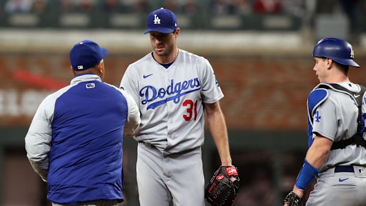Oct 17, 2021; Cumberland, Georgia, USA; Los Angeles Dodgers manager Dave Roberts (30) pulls starting pitcher Max Scherzer (31) cycles during the fifth inning against the Atlanta Braves in game two of the 2021 NLCS at Truist Park. Mandatory Credit: Brett Davis-Imagn Images