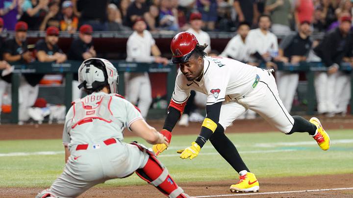 Aug 31, 2026; Phoenix, Arizona, USA; Arizona Diamondbacks base runner Geraldo Perdomo (right) scores against Philadelphia Phillies catcher Garrett Stubbs in the third inning at Chase Field. Mandatory Credit: Mark J. Rebilas-Imagn Images Aug 31, 2026; Phoenix, Arizona, USA; Arizona Diamondbacks base runner Geraldo Perdomo (right) scores against Philadelphia Phillies catcher Garrett Stubbs in the third inning at Chase Field. Mandatory Credit: Mark J. Rebilas-Imagn Images