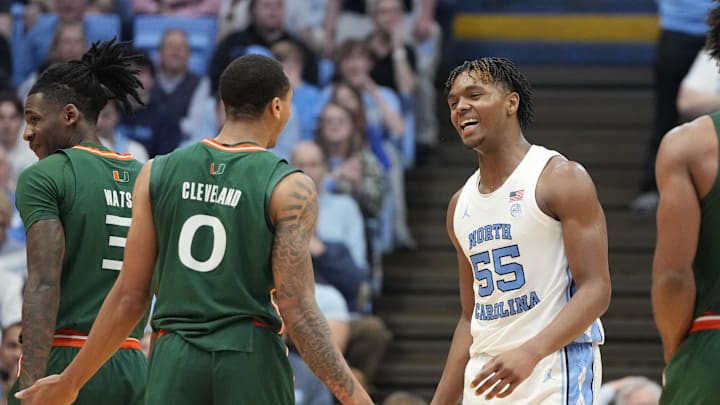 Feb 26, 2024; Chapel Hill, North Carolina, USA; North Carolina Tar Heels forward Harrison Ingram (55) reacts with Miami (Fl) Hurricanes guard Matthew Cleveland (0) in the second half at Dean E. Smith Center. Mandatory Credit: Bob Donnan-Imagn Images