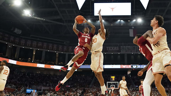 Feb 11, 2025; Austin, Texas, USA; Alabama Crimson Tide guard Labaron Philon (0) drives to the basket while defended by Texas Longhorns guard Tre Johnson (20) during the first half at Moody Center. Mandatory Credit: Scott Wachter-Imagn Images