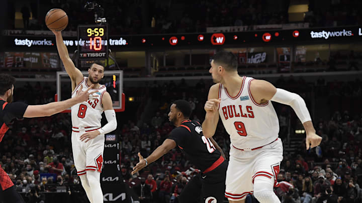 Jan 30, 2022; Chicago, Illinois, USA;  Chicago Bulls guard Zach LaVine (8) passes to Chicago Bulls center Nikola Vucevic (9) as Portland Trail Blazers forward Norman Powell (24) looks on during the first half at the United Center. Mandatory Credit: Matt Marton-Imagn Images